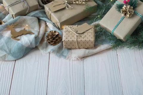 Gift boxes are placed on a handkerchief on a wooden table. There is space for Foto stock