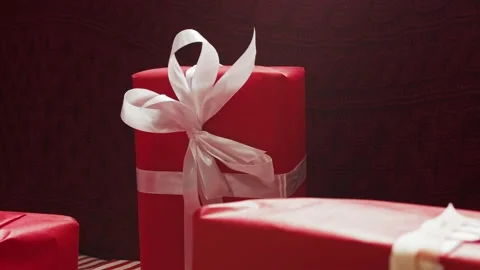 The gift boxes are wrapped in red paper with white ribbon. Stock Footage 144326695