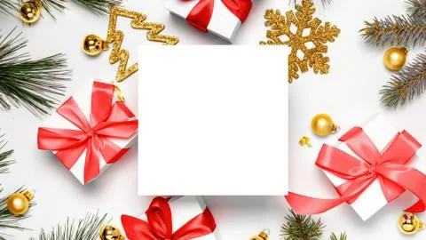 Gift boxes background. White gift box with red ribbon, New Year balls and Chr Stock Photos