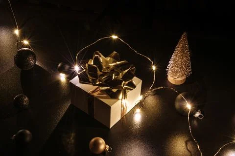 Gift boxes background. White gift box with golden ribbon, New Year balls and  Stock Photos