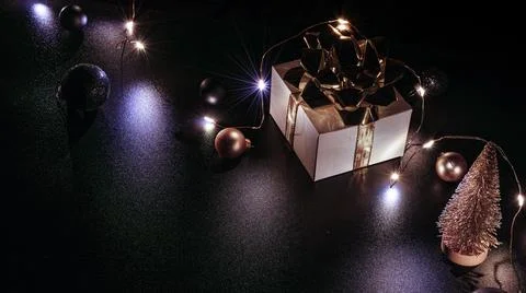 Gift boxes background. White gift box with golden ribbon, New Year balls and  Stock Photos