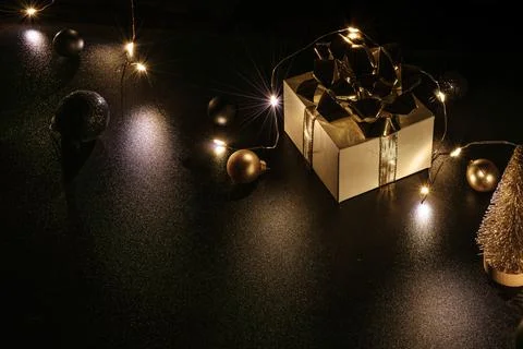 Gift boxes background. White gift box with golden ribbon, New Year balls and  Stock Photos