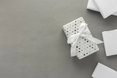 Gift boxes with a bow on a gray concrete background Stock Photos