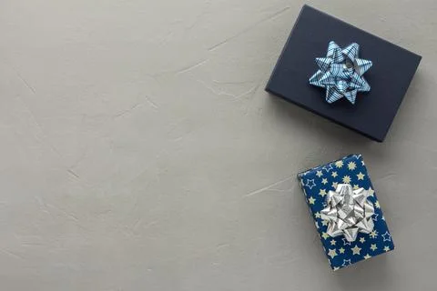 Gift boxes with a bow on a gray concrete background Stock Photos