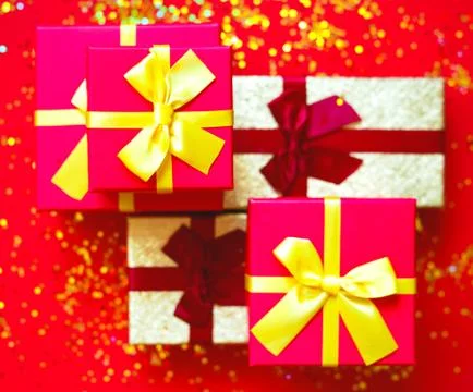 Gift boxes with bow on red-gold background 스톡 사진