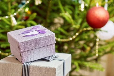 Gift boxes with bows on the lids under a Christmas tree in New Year Eve 写真素材