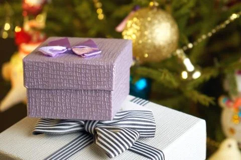 Gift boxes with bows on the lids under a Christmas tree in New Year Eve 写真素材