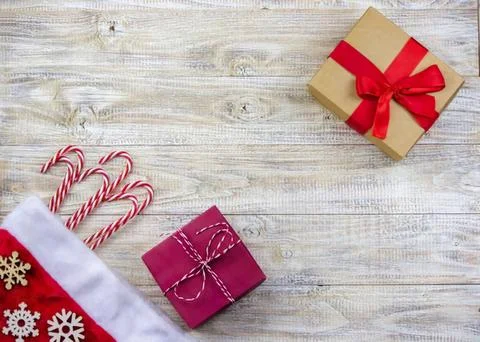 Gift boxes with candy canes and christmas stocking on table Stock Photos
