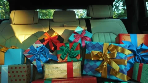 Gift boxes in car. delivery. donation, charity. many beautifully wrapped parcels 스톡 동영상 160916958