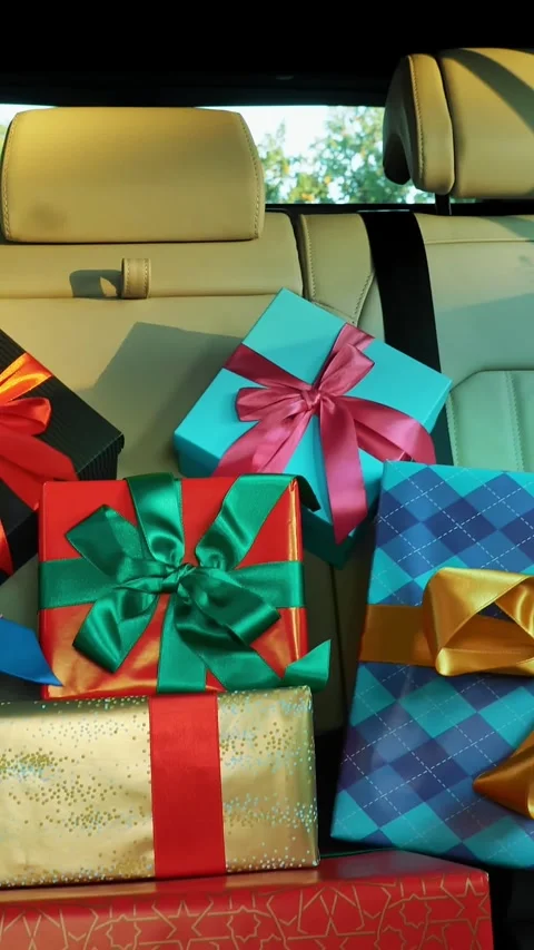 Gift boxes in car. delivery. donation, charity. many beautifully wrapped parcels 스톡 동영상 318807618