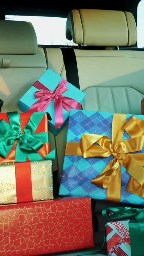 Gift boxes in car. delivery. donation, charity. many beautifully wrapped parcels 스톡 동영상 318807736