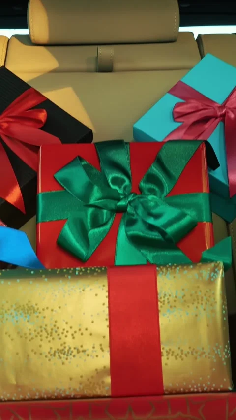 Gift boxes in car. delivery. donation, charity. many beautifully wrapped parcels Stock Footage 319017243