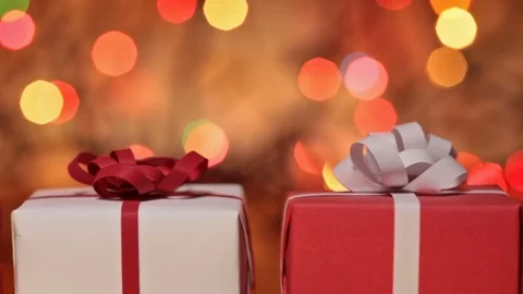 Gift boxes for christmas or other events against blurry lights Video stock 70303408