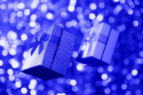 Gift boxes in classic blue on a blurred background. Trend 2020 Stock Illustration
