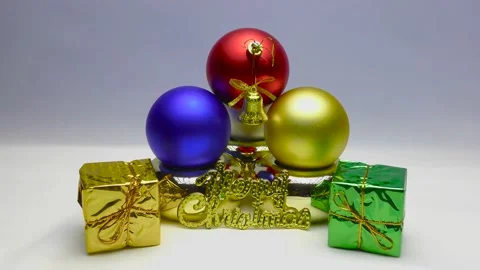Gift boxes in colored wrappers. Gold bells with red ribbons. Christmas frames. Stock Footage 164788098