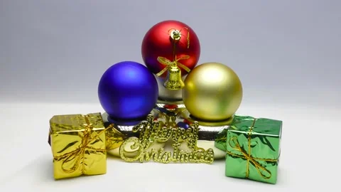 Gift boxes in colored wrappers. Gold bells with red ribbons. Christmas frames. Stock Footage 164788100
