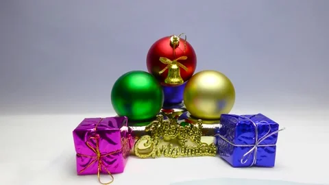 Gift boxes in colored wrappers. Gold bells with red ribbons. Christmas frames. 動画素材 164792010