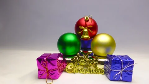 Gift boxes in colored wrappers. Gold bells with red ribbons. Christmas frames. Stock Footage 164792036