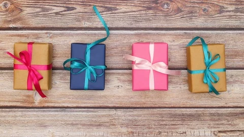 Gift boxes in different colors and bows changing places - Stop motion looping Video stock 123116891