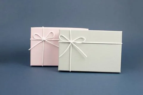 Gift boxes in different sizes and colors in front of a dark blue background 写真素材