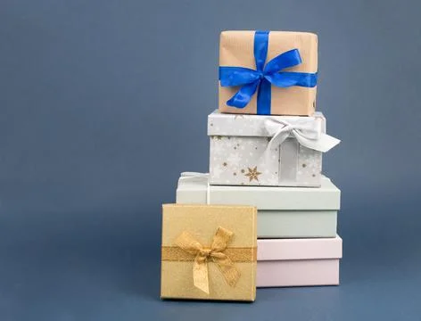 Gift boxes in different sizes and colors in front of a dark blue background,  写真素材