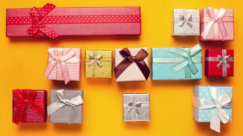 Gift boxes disappears from the  yellow background. Stock Footage 142158710