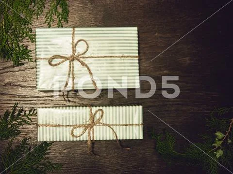 Gift boxes with fir branches on wood background. minimal Christm Stock Photos