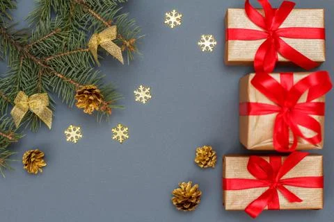 Gift boxes, fir tree branches with cones on gray background Stock Photos