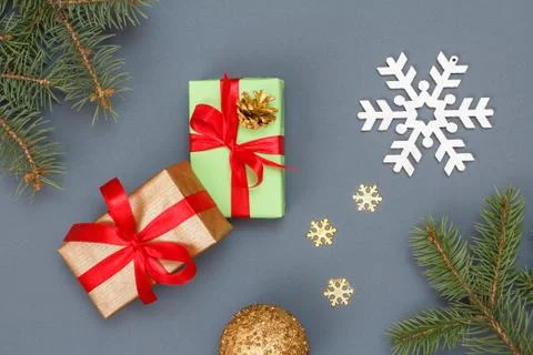 Gift boxes, fir tree branches and christmas toys on gray background Stock Photos