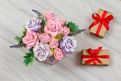Gift boxes with flowers on the gray background Stock Photos
