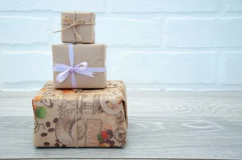 Gift boxes on gray table against white loft background. Greeting card. Stock Photos