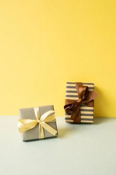 Gift boxes on gray table. yellow wall background Stock Photos