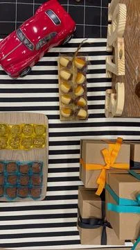 Gift boxes with handmade sweets and toy car Stock Photos