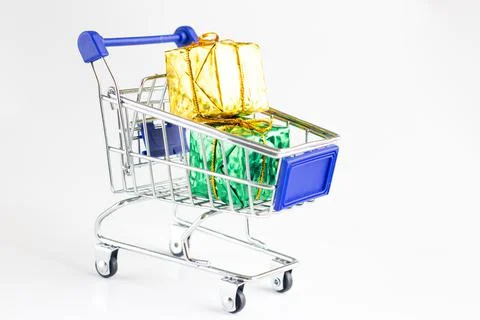 Gift boxes inside the toy shopping trolley. Stock Photos