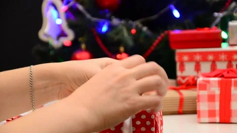 Gift boxes with a large red bow against a  bokeh. Christmas gift. 動画素材 166552226
