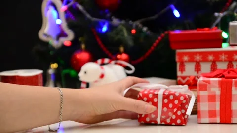 Gift boxes with a large red bow against a  bokeh. Christmas gift. 動画素材 166552234