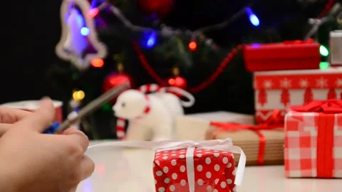 Gift boxes with a large red bow against a  bokeh. Christmas gift. 動画素材 166552241