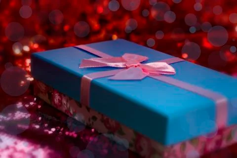 Gift boxes lie on a red shiny fabric. Package of gifts for Christmas.bokeh, s Stock Photos