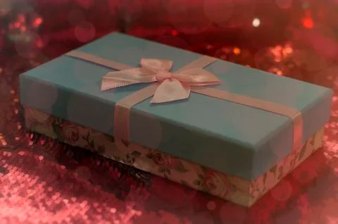 Gift boxes lie on a red shiny fabric. Package of gifts for Christmas.bokeh, s Stock Photos