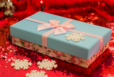 Gift boxes lie on a red shiny fabric. Package of gifts for Christmas.bokeh, s Stock Photos