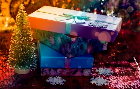 Gift boxes lie on a red shiny fabric. Package of gifts for Christmas.bokeh, s Stock Photos