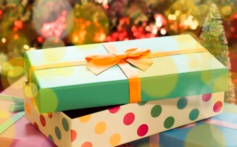Gift boxes lie on a red shiny fabric. Package of gifts for Christmas.bokeh, s Stock Photos