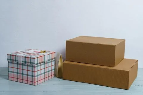 Gift boxes on a light table on a white background. Stock Photos