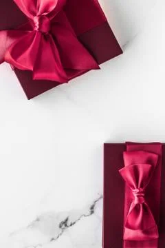 Gift boxes on marble background, holiday flatlay Stock Photos
