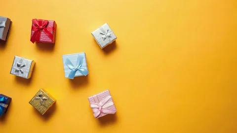 Gift boxes moving from the left side and stopping on yellow background. Stock Footage 142027419