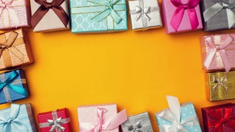 Gift boxes moving on yellow background.Holiday and celebrating concept. Stock Footage 142329359