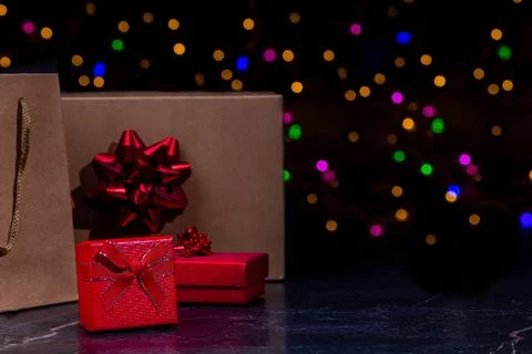 Gift boxes or packages on a dark marble background. Colorful bokeh on background 写真素材