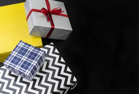 Gift boxes over black background with copy space Stock Photos
