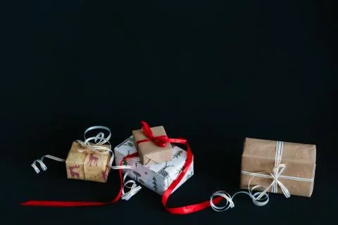 Gift boxes Packed in wrapping paper and tied with ribbons for the new year or Stock Photos
