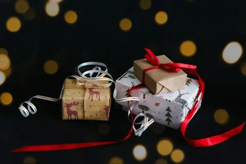 Gift boxes Packed in wrapping paper and tied with ribbons for the new year or Stock Photos